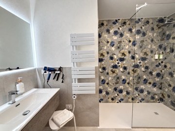 Bagno Deluxe con doccia e rivestimento floreale
